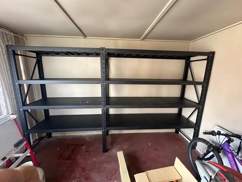 Black Metal Shelves In A Garage Room — professional shelving installation
