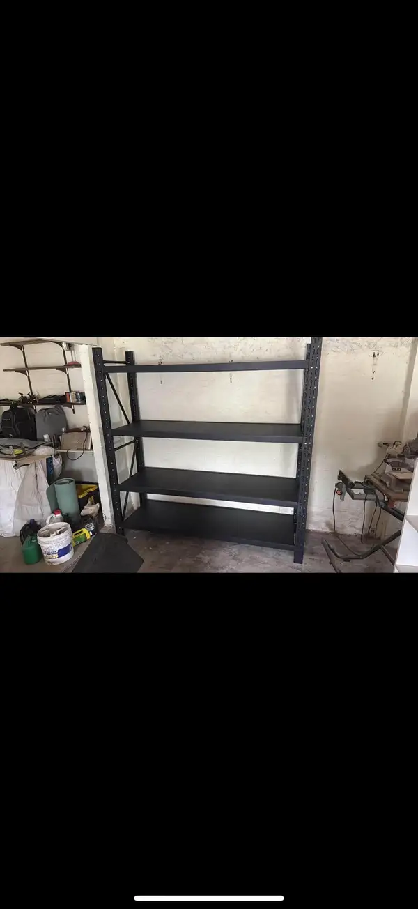 Empty black metal shelves in a garage