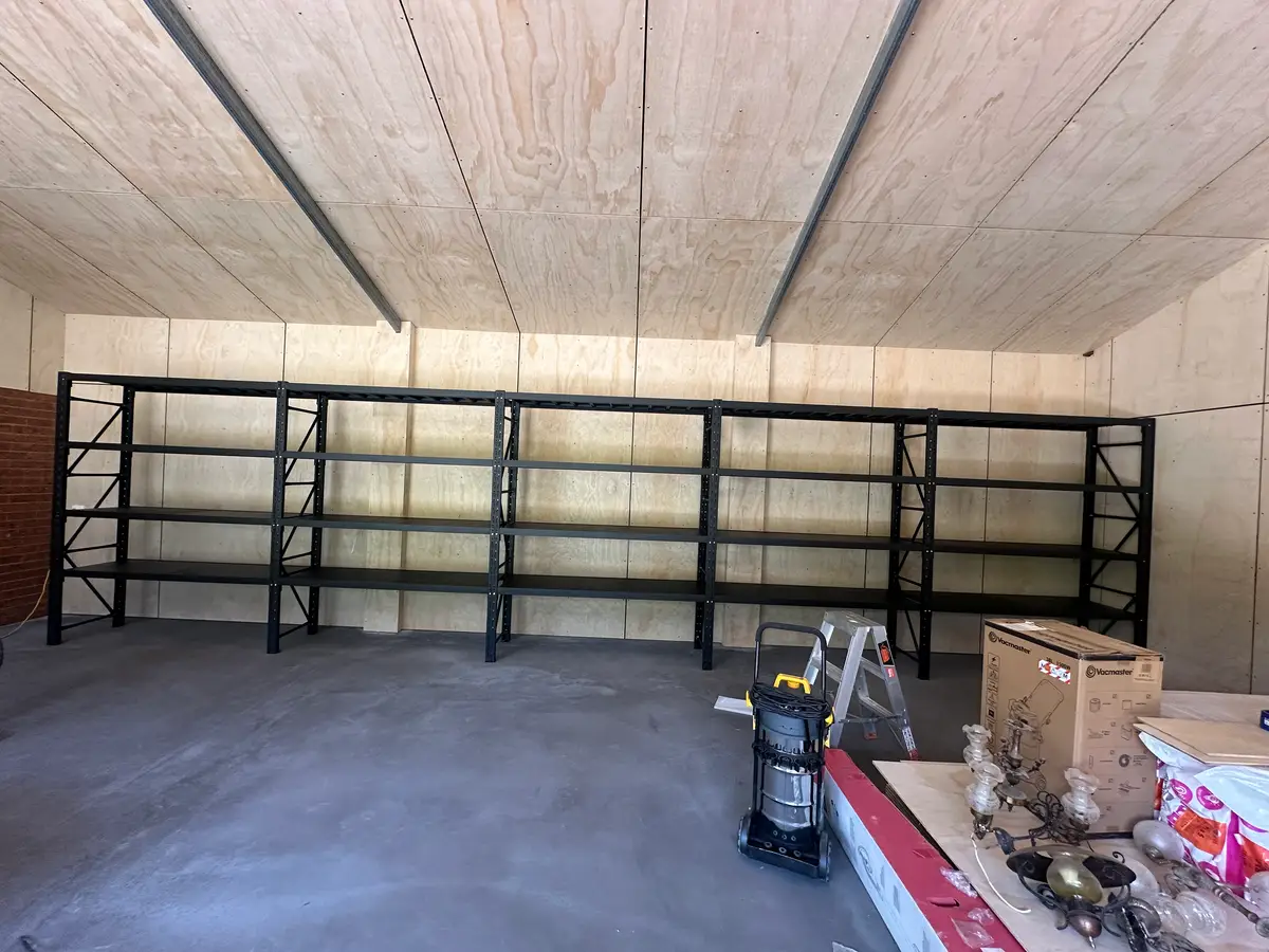 Empty metal shelves in a wooden ceiling room