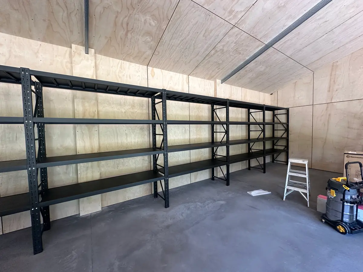 Empty storage shelves in unfinished wooden room